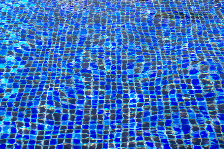 Ripple and flow with waves swimming pool bottom background.の写真素材