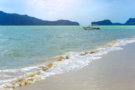 Boat on blue water and white sand beach in thailand sea, Satun Province.の写真素材