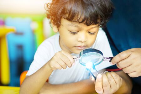 3 year old children in Asia are conducting scientific experiments for education.
