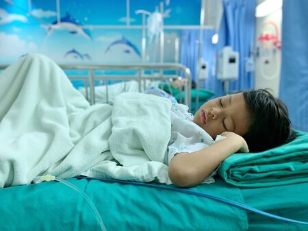 An Asian boy who is ill with Adenoid disease and recently underwent surgery to remove the Adenoid gland.の写真素材
