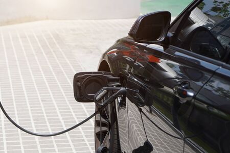 Electric cars are charging electricity to store in car batteries. Electric cars have become popular around the world To reduce air pollution.の写真素材