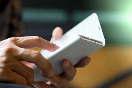Focus hand of Young asian man touching smartphone, Young male use smartphone for chat and surfing...