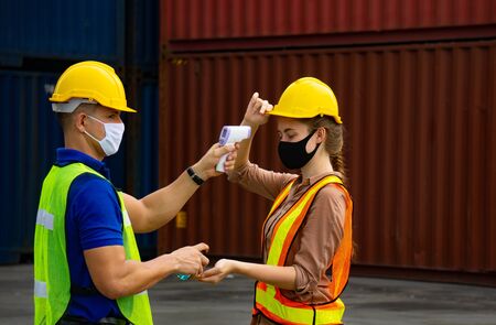 Check body temperature Before working in the warehouse To prevent the spread of covid-19の写真素材