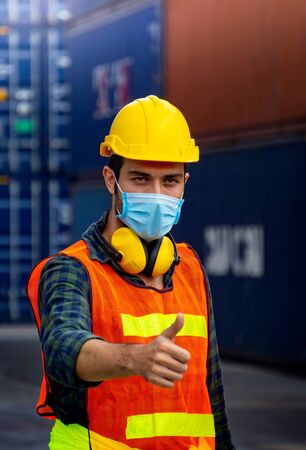 Male workers in the transport industry have hygienic masks to prevent the spread of the Covid 19 virus in the factory.の写真素材