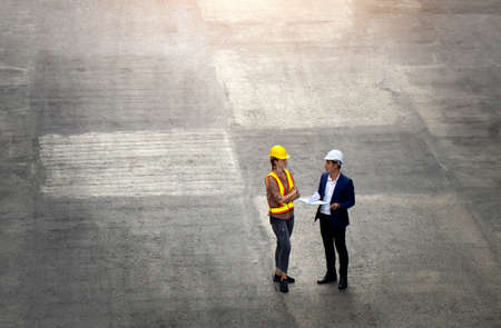 Women industrial workers and engineer are discussing the job planning in the logistic industry.