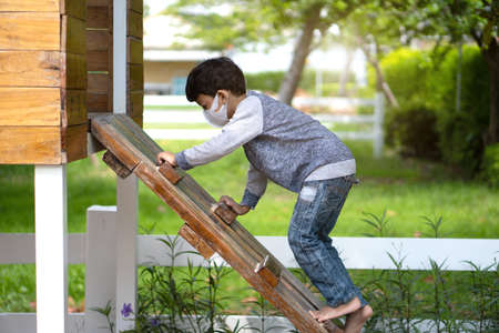 4-5 years old Asian Little boy climbing ladder on playground.の写真素材