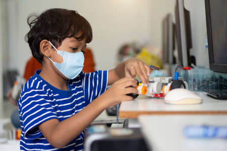 Asian boy wear face masks to prevent the Coronavirus 2019 (COVID-19) in schools.