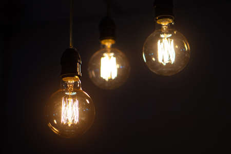 incandescent light bulb, incandescent lamp or incandescent light globe on dark backgroundの写真素材