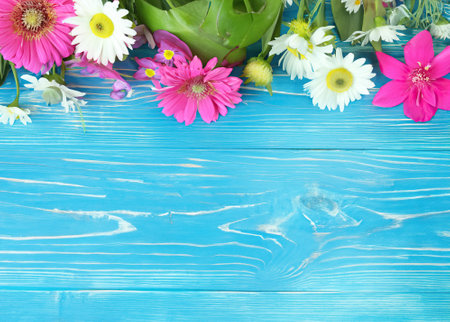 Purple and white flower on blue wooden background from top view.の素材