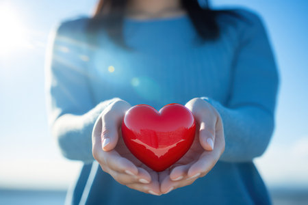 "Tender Gesture, Woman Holds Heart Shape in Hand"の素材