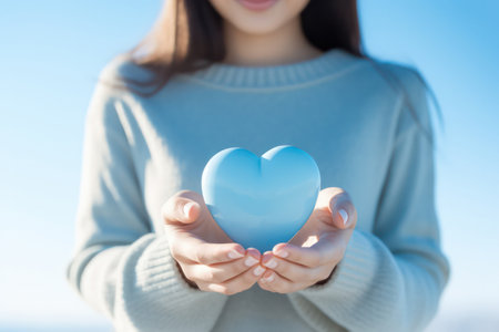 "Tender Gesture, Woman Holds Heart Shape in Hand"の素材