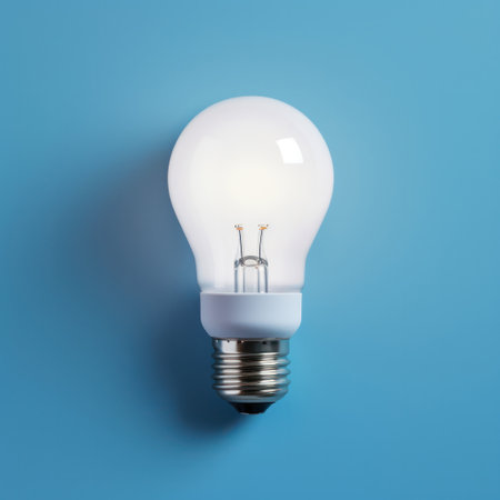 "Glowing Innovation, LED Light Bulb Illuminates on Blue Background - Modern Lighting Technology."の素材