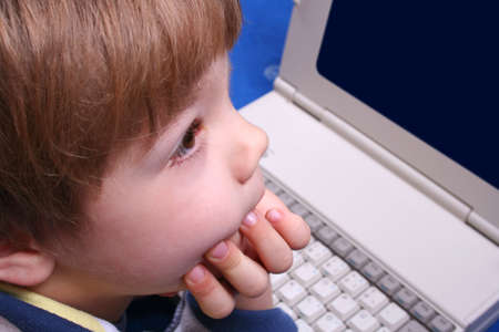 A young boy and laptopの写真素材
