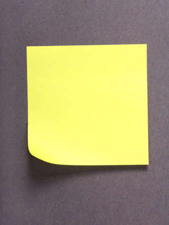 yellow note over grey backgroundの写真素材