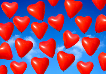 Valentine heart balloons against blue sky background.の写真素材