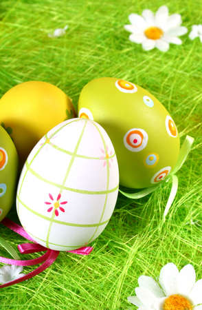 colored eggs in the grassの写真素材