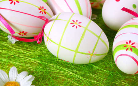colored eggs in the grassの写真素材