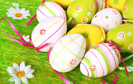 colored eggs in the grassの写真素材