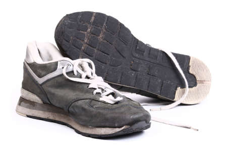 Old grungy Running Shoes isolated on white backgroundの写真素材