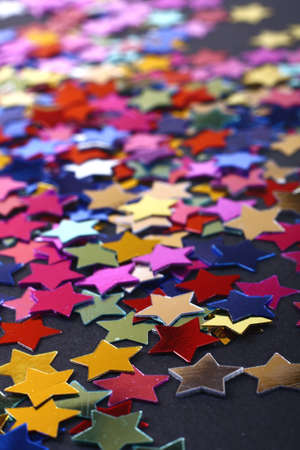 Stars in the form of confetti on blackの写真素材
