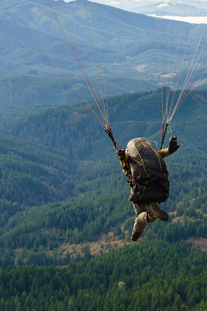 Paraglider just as he lifts off the ground controlling the wing with brakes.