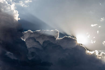 Clouds and Light. Sunlight backlights clouds with blue sky.の写真素材