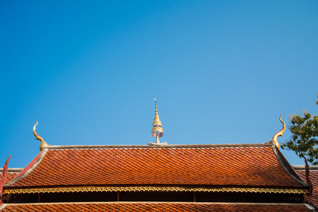Beautiful roof tiles of temple in Chiang mai, Thailand blue skyの写真素材