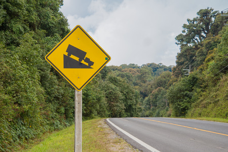 warning steep road sign slop and truck on hillの写真素材