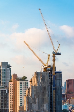 Construction site with crane over a building in morningの写真素材