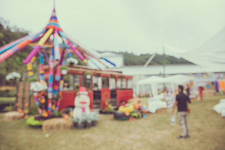 Abstract blur people in day festival bokeh background - vintage festival outdoor fairの写真素材