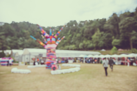 Abstract blur people in day festival bokeh background - vintage festival outdoor fairの写真素材