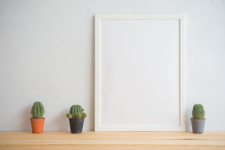 Photo frame and cactus pots mockup with white wall background, creative ideas slow life conceptの写真素材