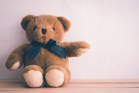 Teddy bear doll on white wall background - Retro toneの写真素材