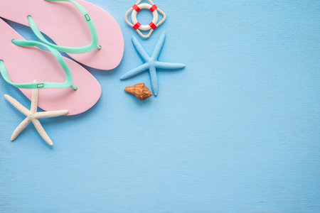 Flat lay of tropical beach summer holiday with beach summer accessories for traveling on blue wooden...