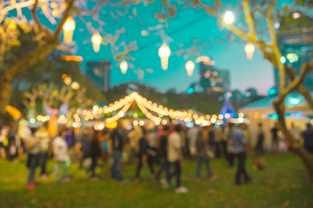 Abstract blur people in night festival city park bokeh background - Vintage toneの写真素材