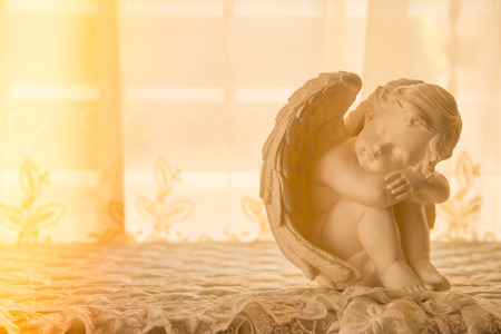 Cute cupid statue with beautiful light leakの写真素材