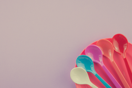 Colorful spoons and dish on purple background - Retro filter effectの写真素材