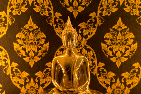 Buddha statue with warm lighting in Thai house for prayingの写真素材