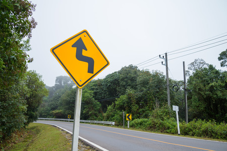 Winding road sign on the mountainの写真素材