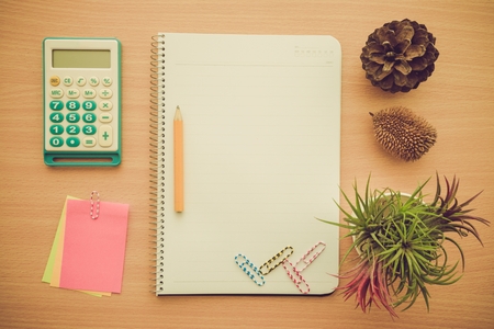 Above view of blank lined notepad and stationery on wooden table - Retro filter effectの写真素材