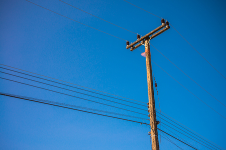 Electric post with net against blue skyの写真素材