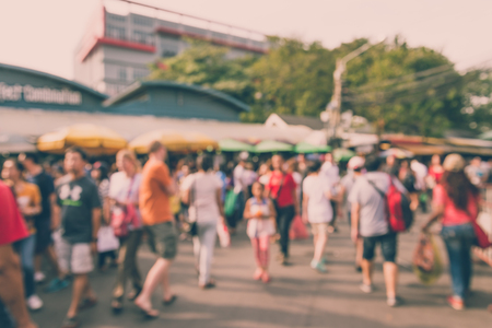 Abstract blur tourist shopping in Chatuchak weekend market outdoor in sunny day Bangkok Thailand background - Vintage filter effectの写真素材