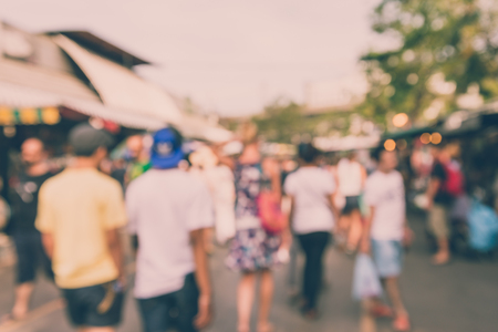 Abstract blur tourist shopping in Chatuchak weekend market outdoor in sunny day Bangkok Thailand background - Vintage filter effectの写真素材