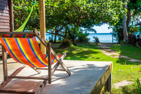 Colorful beach chair in front of resort hut Koh Mak, Trat Thailand - Selective focusの写真素材