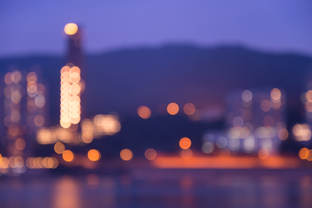 Abstract blur seaside night cityscape in twilight evening with reflection backgroundの写真素材