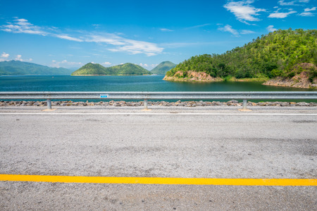 Beautiful road with blue sky on Srinagarind dam in Kanchanaburi Thailandの写真素材