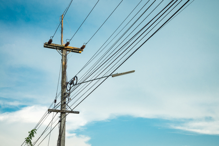 Electric post against blue skyの写真素材