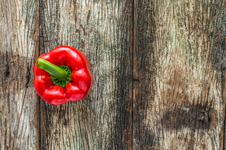 Red sweet pepper on old wooden background - Selective focusの写真素材
