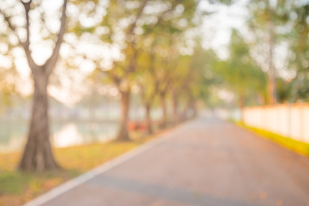 Abstract blur city park with warm sunlight in morning backgroundの写真素材