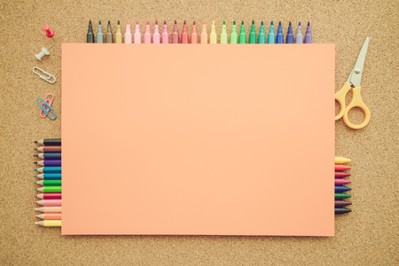Top view of education and art supplies on cork table with empty space color paper - Retro filter effectの写真素材